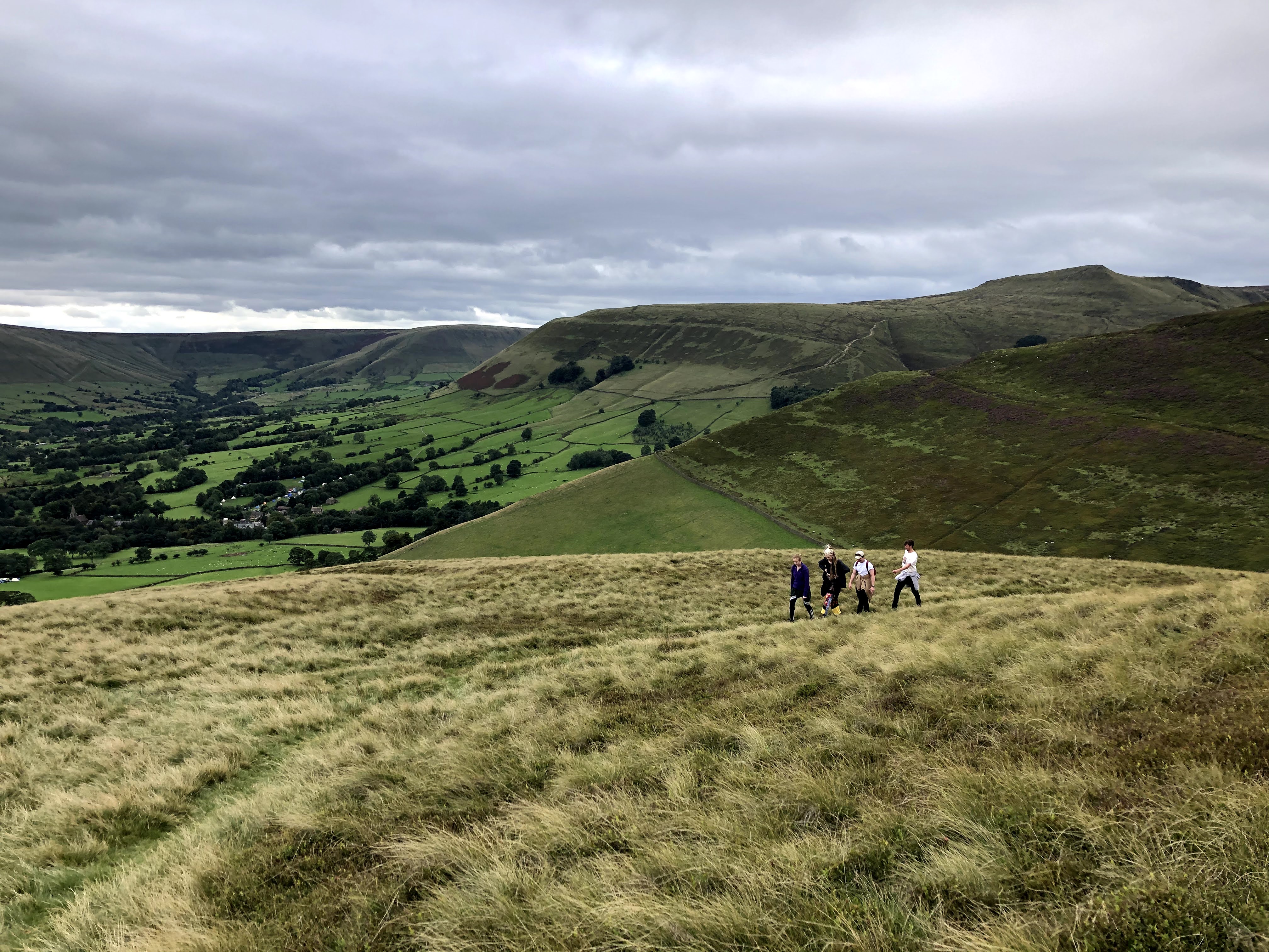 Scenic view of rolling hills and valleys, showcasing lush greenery and dramatic mountain landscapes